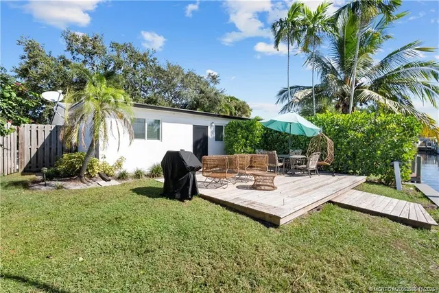 a view of a house with backyard and sitting area