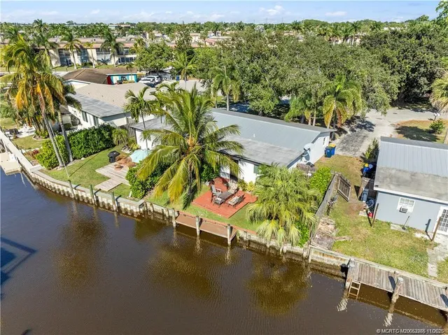 a view of a swimming pool with a lawn chairs under an umbrella