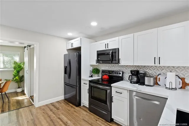 a kitchen with a refrigerator stove and microwave