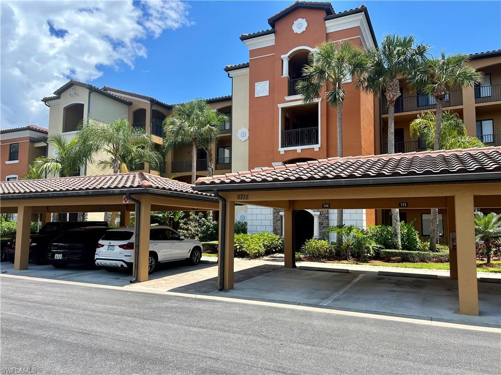 9715 Acqua Court, Unit 125 Naples, FL 34113 - Photo 1 of 24 front view of a building with a street
