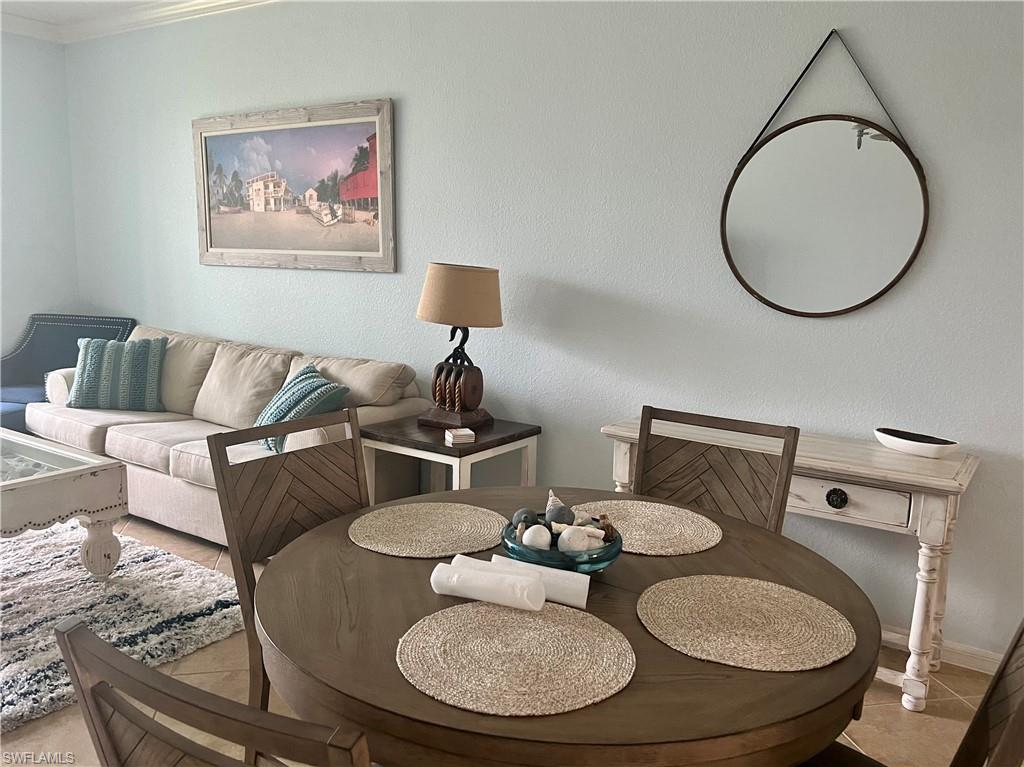 9715 Acqua Court, Unit 125 Naples, FL 34113 - Photo 8 of 24 a living room with furniture and a mirror