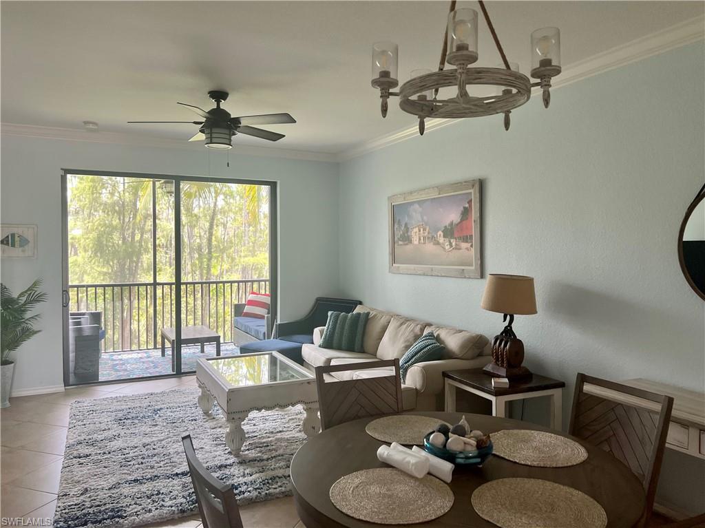 9715 Acqua Court, Unit 125 Naples, FL 34113 - Photo 9 of 24 a living room with furniture and a floor to ceiling window