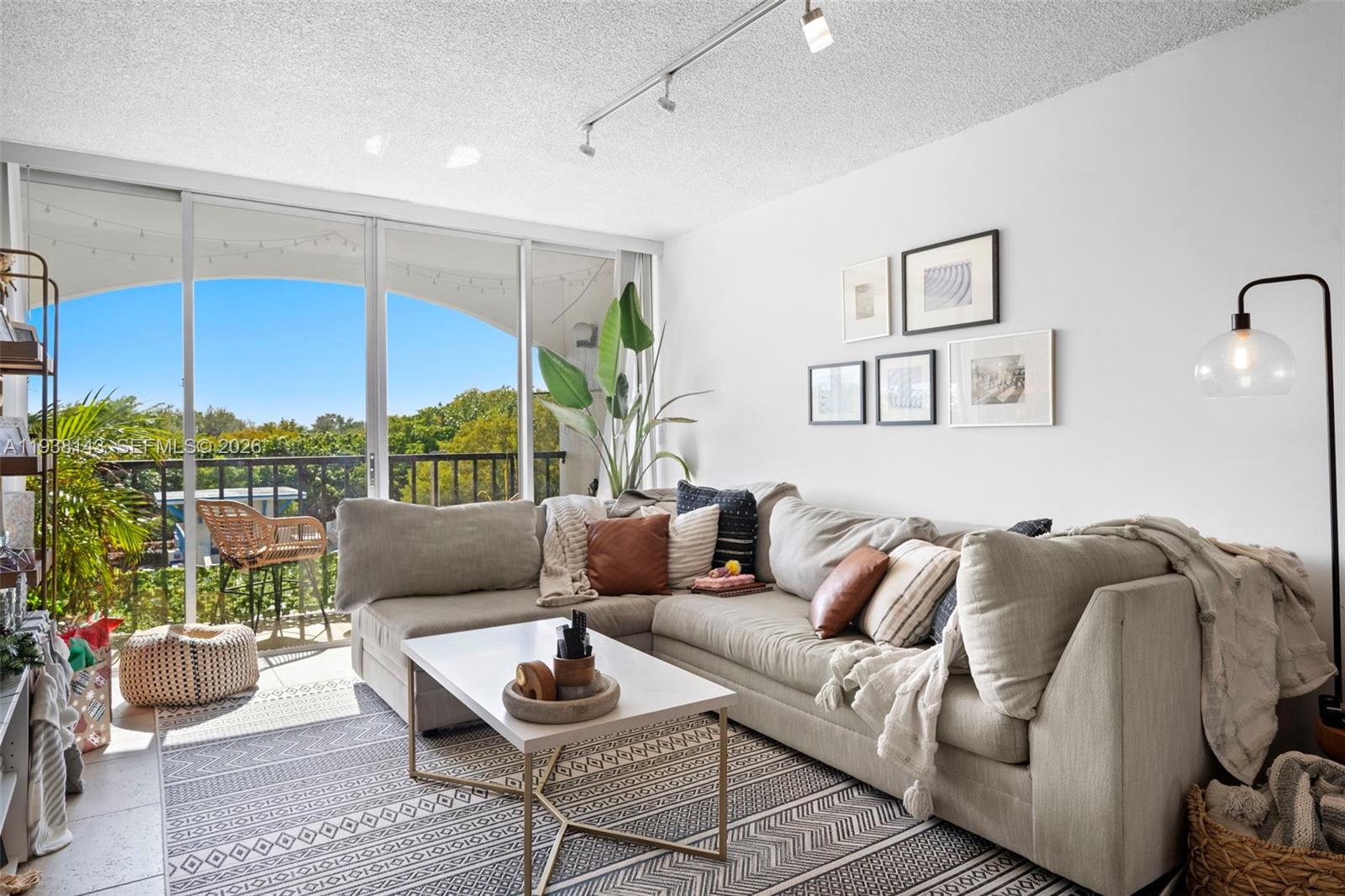 2150 Southwest 16th Avenue, Unit 402 Miami, FL 33145 - Photo 1 of 25 a living room with furniture and a floor to ceiling window