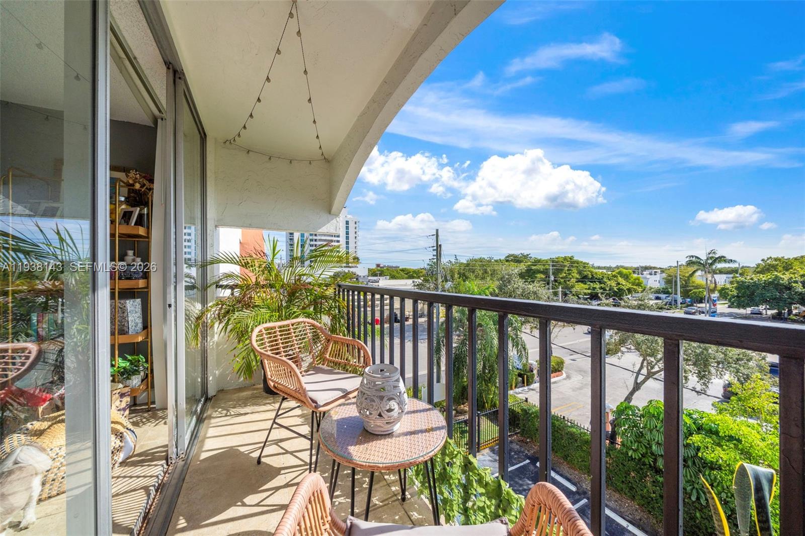2150 Southwest 16th Avenue, Unit 402 Miami, FL 33145 - Photo 5 of 25 a view of a chair and tables in the balcony