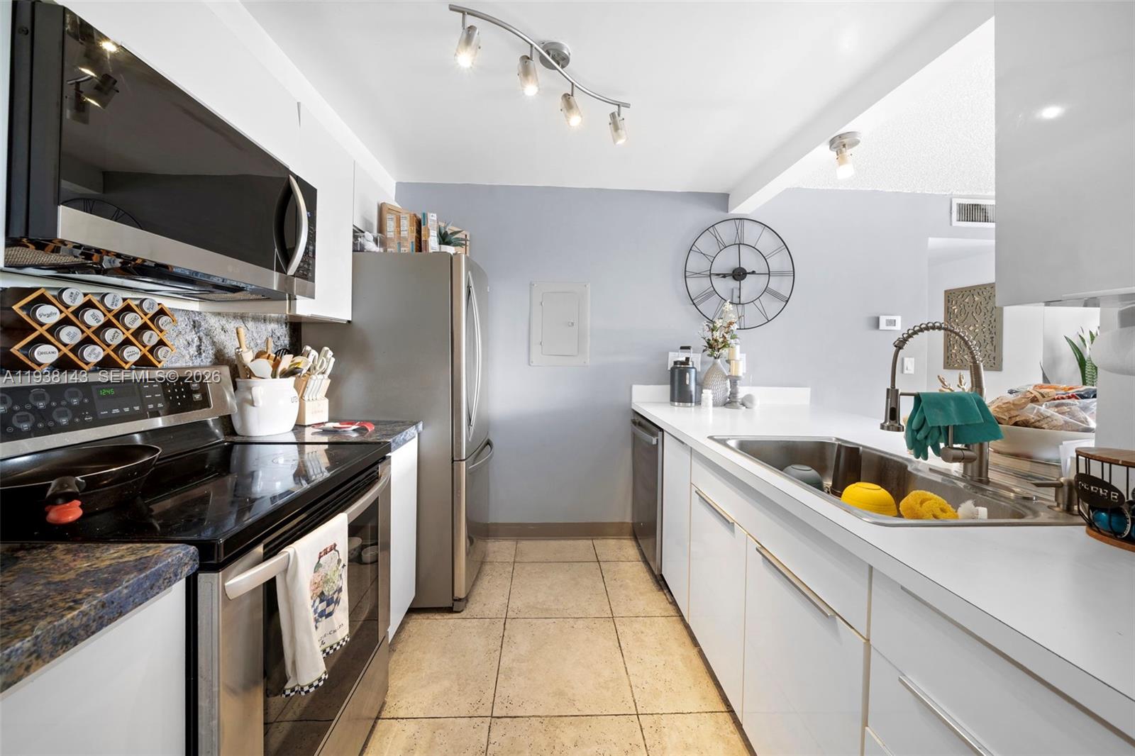 2150 Southwest 16th Avenue, Unit 402 Miami, FL 33145 - Photo 9 of 25 a kitchen with stainless steel appliances granite countertop a sink and a stove