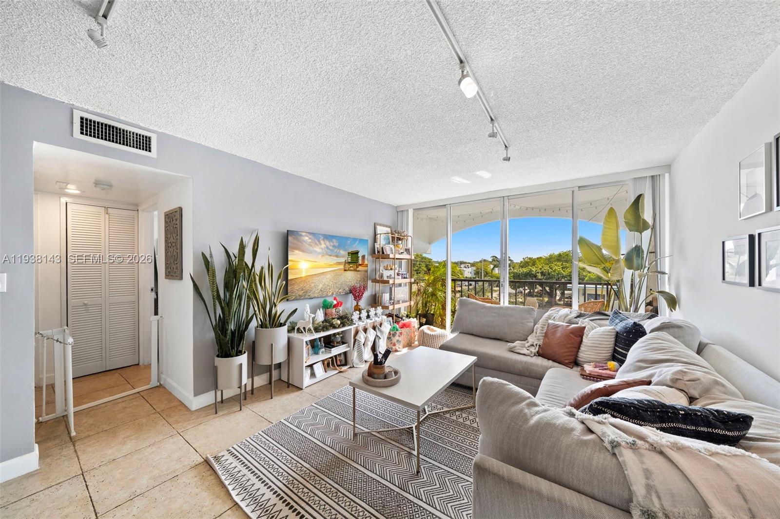 2150 Southwest 16th Avenue, Unit 402 Miami, FL 33145 - Photo 10 of 25 a living room with furniture and a potted plant