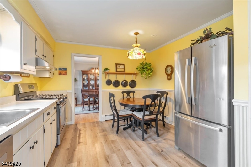 79 Main Street Califon, NJ 07830 - Photo 15 of 50 a kitchen with stainless steel appliances a dining table chairs and wooden floor