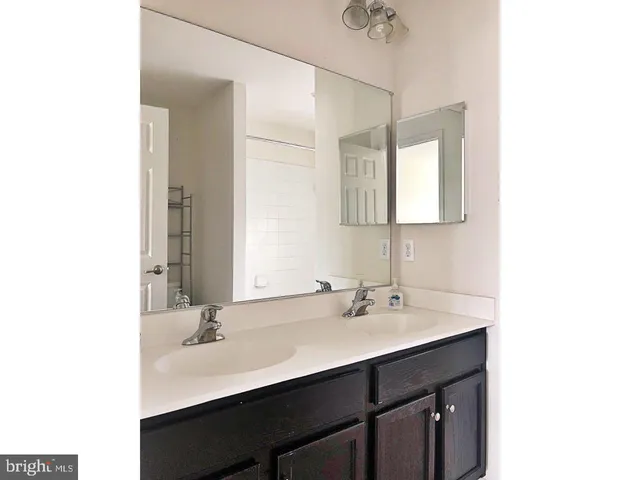 a spacious bathroom with a bathtub and sink