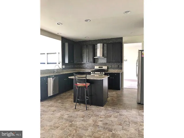 a kitchen with a sink cabinets and appliances