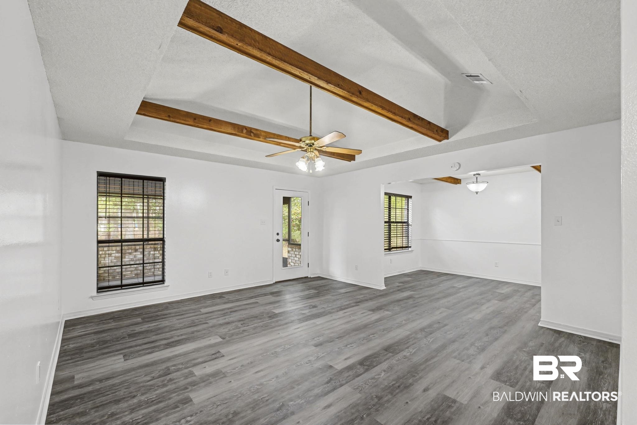 2776 Santa Rosa Circle Lillian, AL 36549 - Photo 16 of 48 Spare room featuring a textured ceiling, beam ceiling, wood finished floors, healthy amount of natural light, and ceiling fan