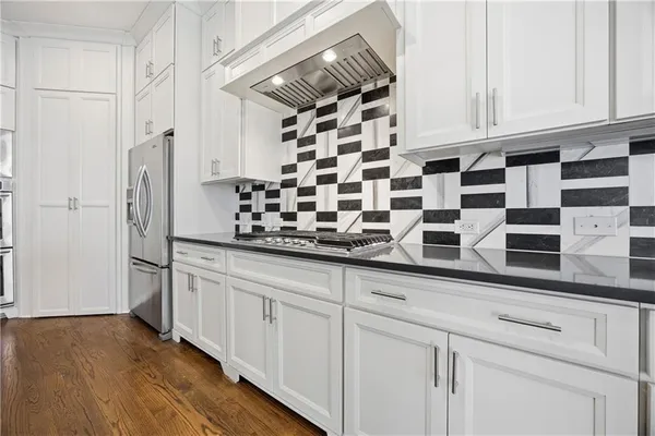 a kitchen with stainless steel appliances a sink and cabinets