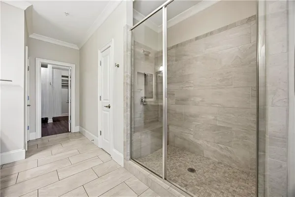 a bathroom with a shower and a glass door