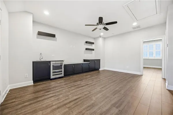 a view of a room with wooden floor and ceiling fan