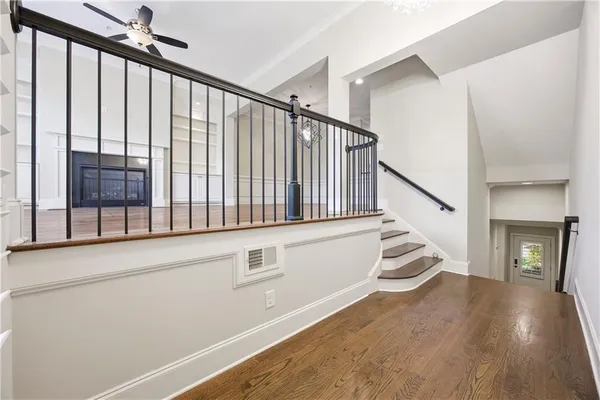 a view of entryway and hall with wooden floor