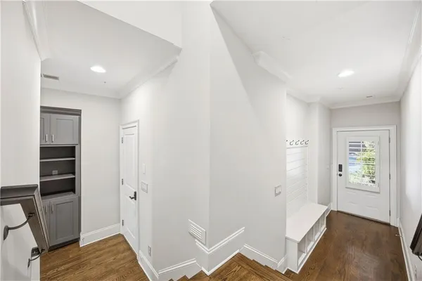 a view of room with hardwood floor and hallway