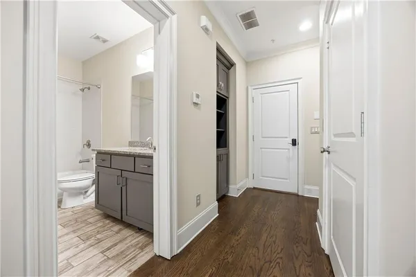 a view of a hallway with wooden floor