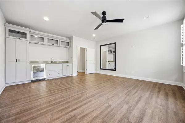 a view of a livingroom with a hardwood floor and a ceiling fan
