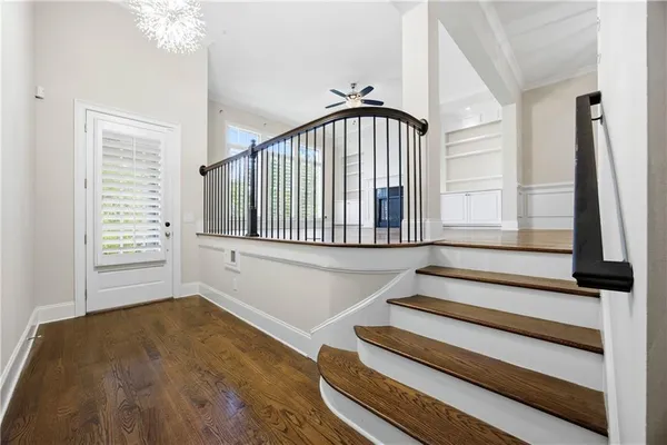 a view of staircase with white walls and a window