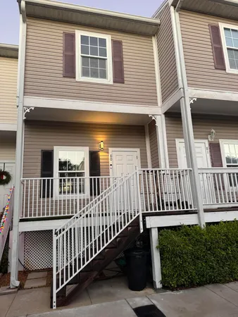 a view of a house with wooden fence