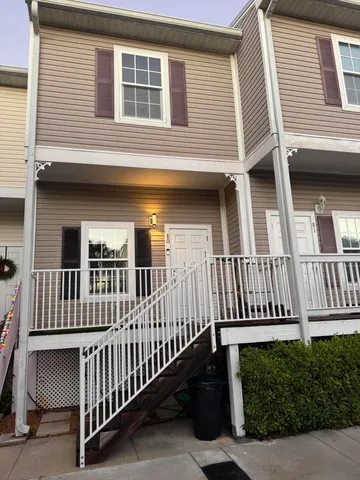 a view of a house with wooden fence