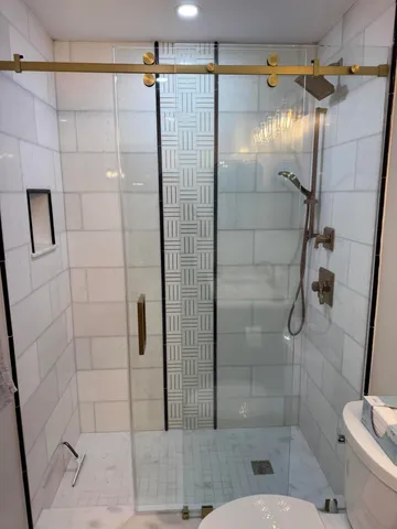 a bathroom with a shower and toilet