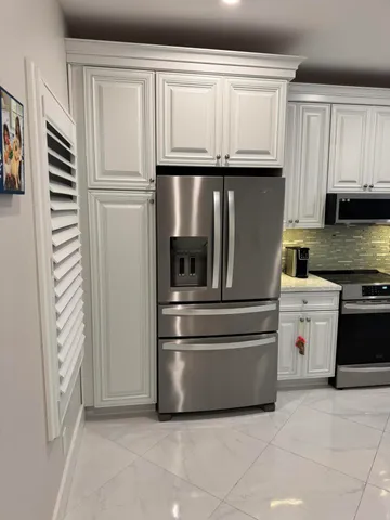 a kitchen with appliances and cabinets