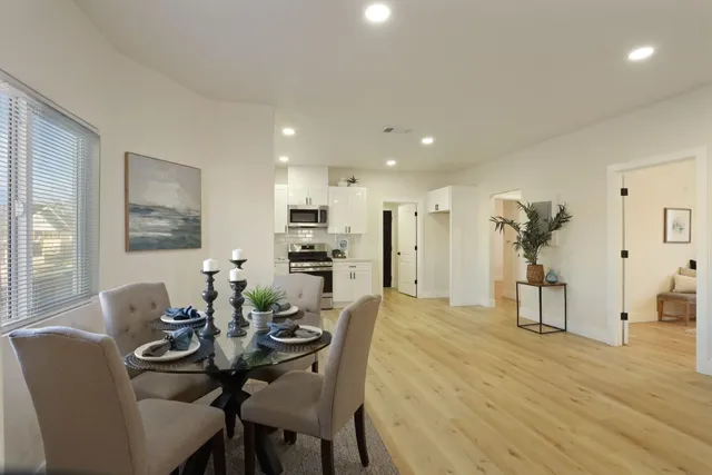 a kitchen with stainless steel appliances granite countertop a stove a sink and a microwave