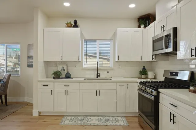 a kitchen with stainless steel appliances granite countertop a sink and cabinets