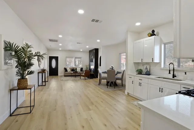 a kitchen with white cabinets and counter space