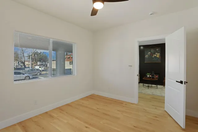 a view of empty room with wooden floor