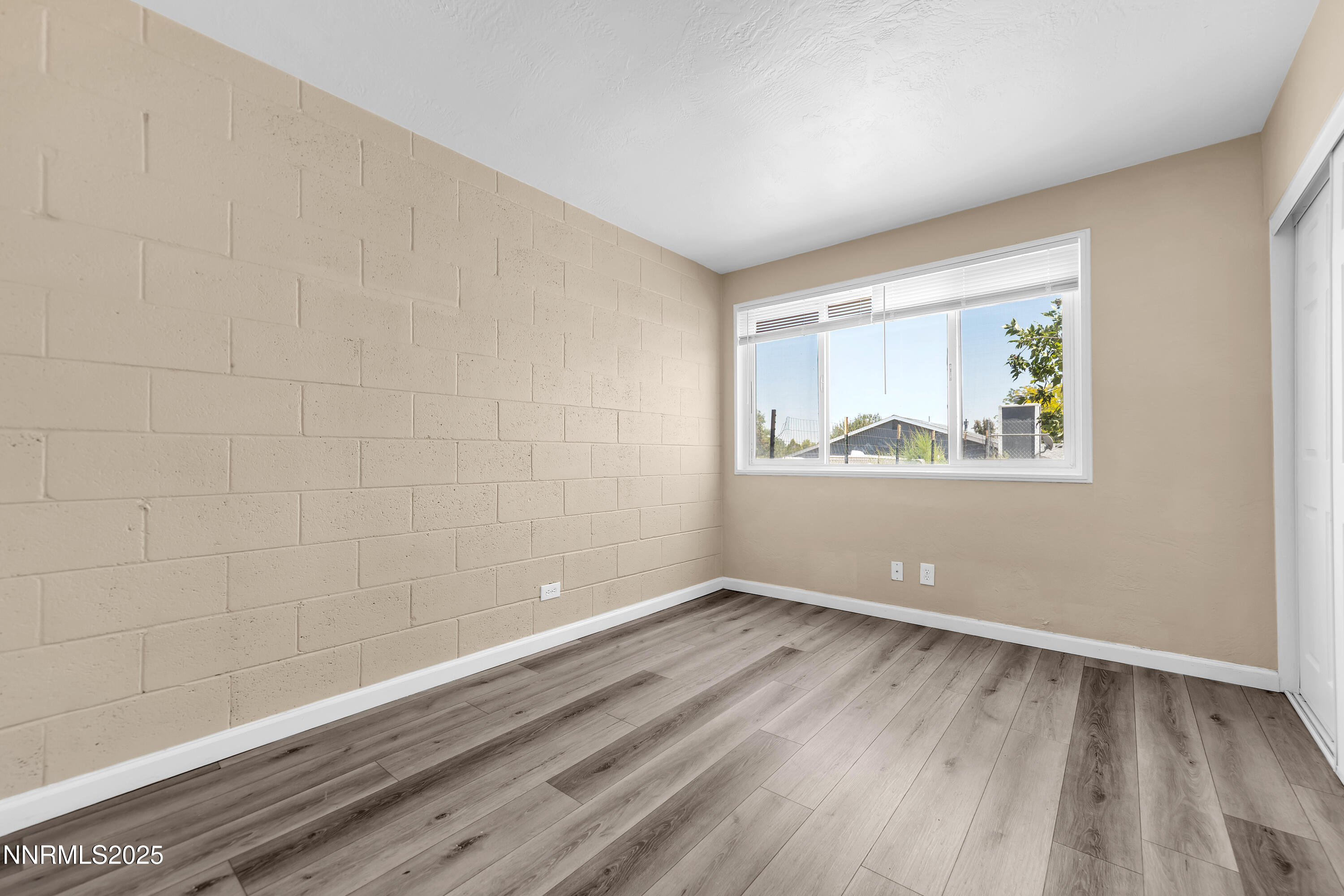 12190 Rocky Mountain Street Reno, NV 89506 - Photo 11 of 27 a view of empty room with wooden floor and fan