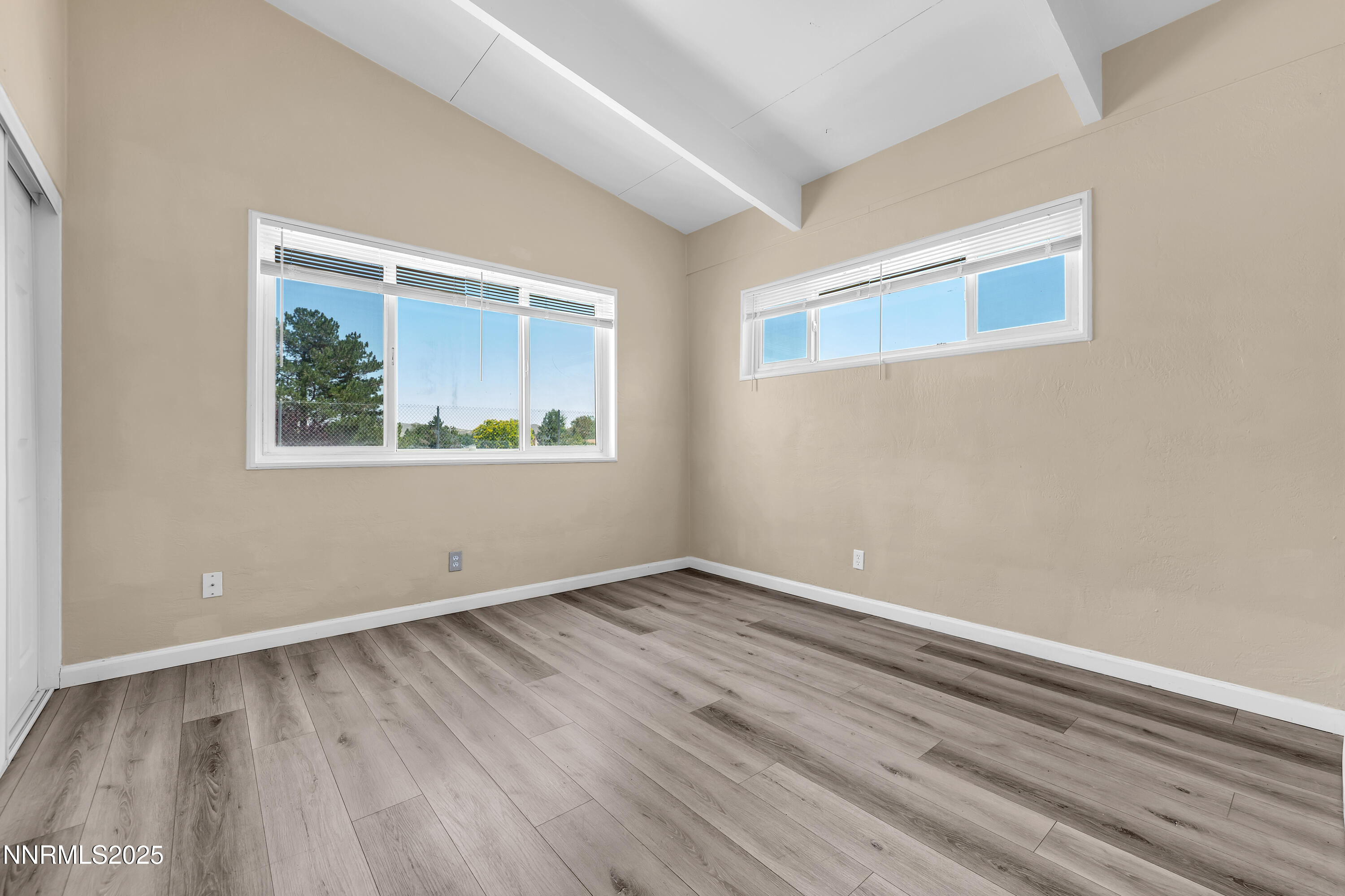 12190 Rocky Mountain Street Reno, NV 89506 - Photo 14 of 27 a view of an empty room with wooden floor and a window