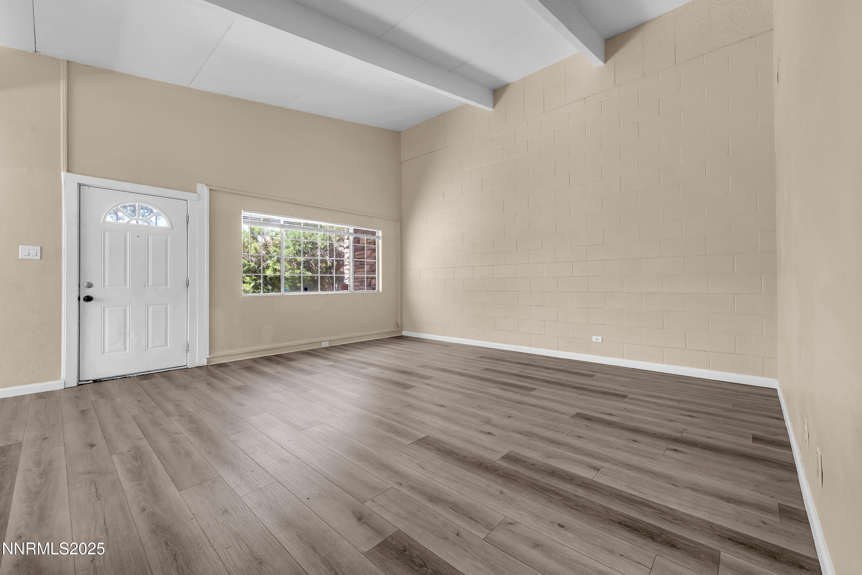 12190 Rocky Mountain Street Reno, NV 89506 - Photo 4 of 27 a view of an empty room with wooden floor and a window