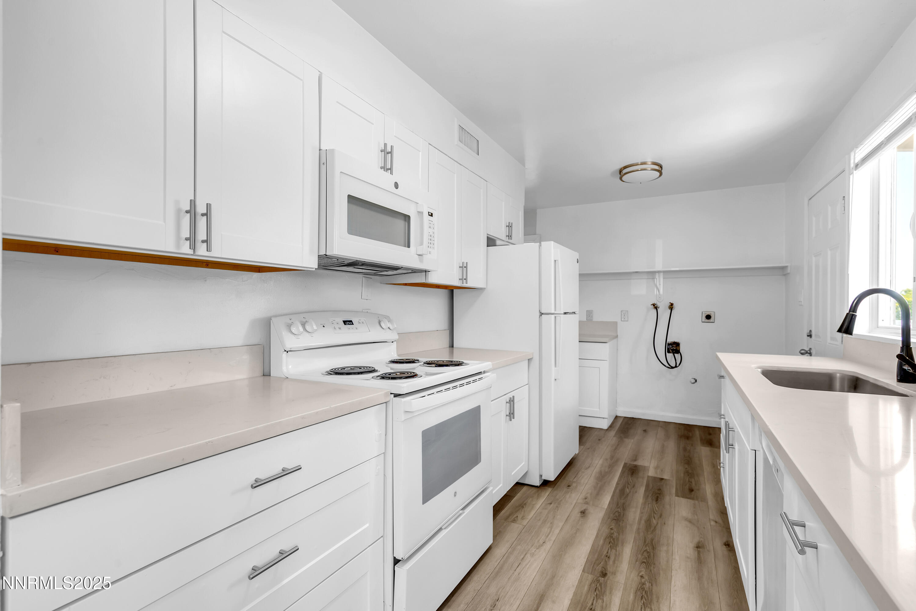 12190 Rocky Mountain Street Reno, NV 89506 - Photo 9 of 27 a kitchen with stainless steel appliances granite countertop white cabinets sink and stove