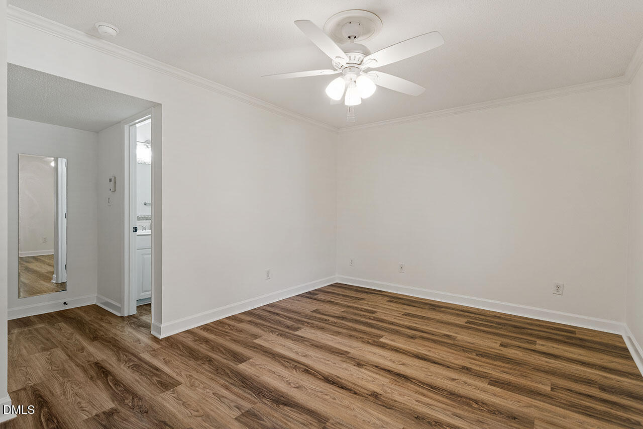 2306 Stafford Avenue, Unit D Raleigh, NC 27607 - Photo 21 of 24 a view of a room with wooden floor and chandelier fan