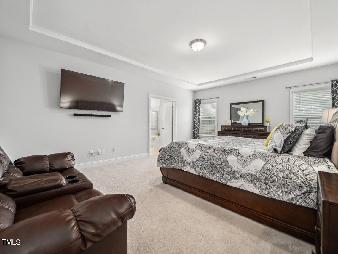 2609 Princess Tree Drive Raleigh, NC 27616 - Photo 15 of 23 a bedroom with a bed and a flat screen tv