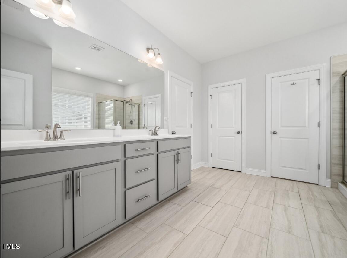 2609 Princess Tree Drive Raleigh, NC 27616 - Photo 16 of 23 a bathroom with a double vanity sink and mirror