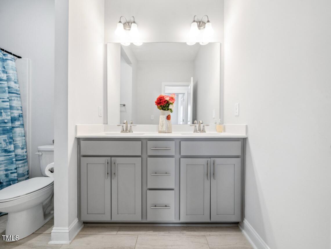 2609 Princess Tree Drive Raleigh, NC 27616 - Photo 20 of 23 a bathroom with a sink vanity and a toilet