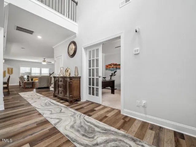 a living room with furniture a rug and gym equipment