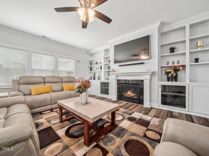 2609 Princess Tree Drive Raleigh, NC 27616 - Photo 6 of 23 a living room with furniture a flat screen tv and a fireplace