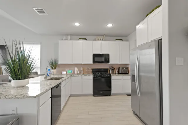 a kitchen with kitchen island a counter space a sink and stainless steel appliances
