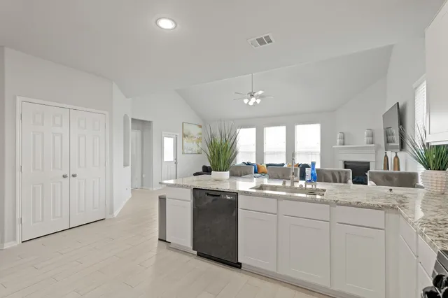 a kitchen with a sink stove and cabinets