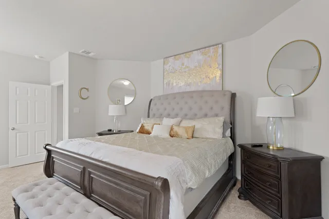 a bedroom with a bed and a chandelier