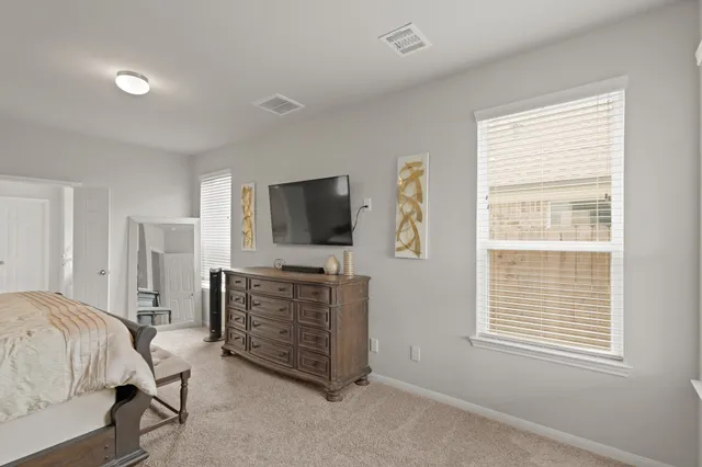 a bedroom with a bed and a television in it