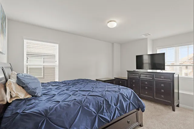 a bedroom with a bed and flat screen tv