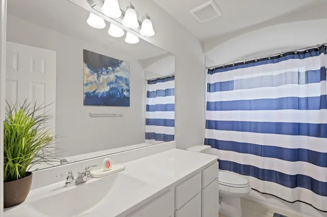 a bathroom with a sink a large mirror and a shower