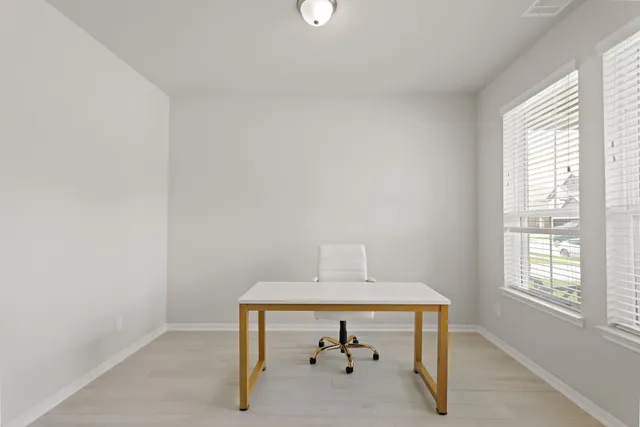 a room with a table and windows