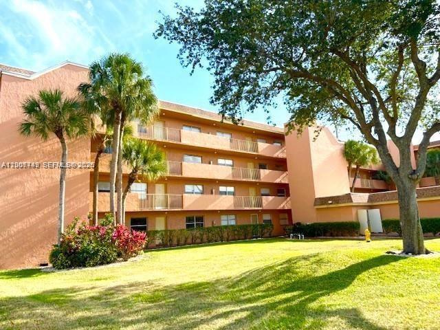 3120 North Pine Island Road, Unit 307 Sunrise, FL 33351 - Photo 12 of 16 a front view of house with yard and green space