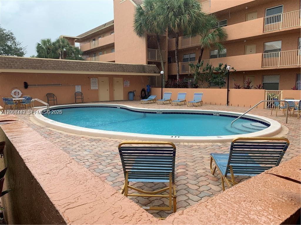 3120 North Pine Island Road, Unit 307 Sunrise, FL 33351 - Photo 13 of 16 a view of a swimming pool with a patio