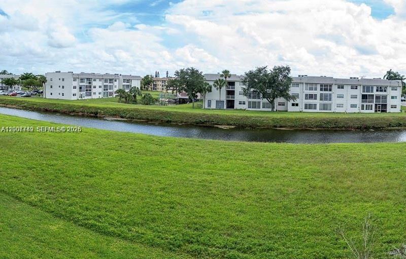 3120 North Pine Island Road, Unit 307 Sunrise, FL 33351 - Photo 14 of 16 an aerial view of a house with a garden and lake view